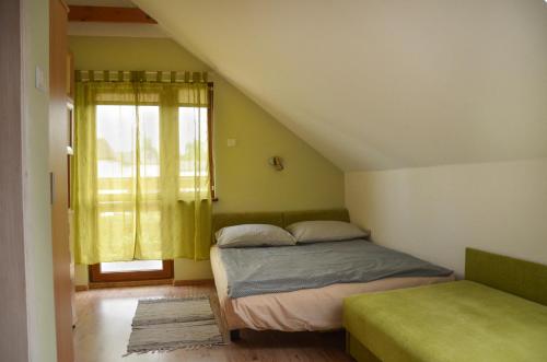 a bedroom with a bed and a window at bliźniak-apartamenty in Rowy