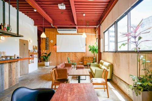 a meeting room with tables and chairs and a whiteboard at fan! ABURATSU in Nichinan