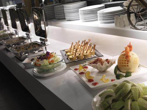 a buffet line with different types of food on display at CityInn Hotel Plus - Taichung Station Branch in Taichung