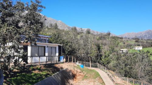 a house on the side of a hill at Parcela Paso del León (Cabañas) in Olmué