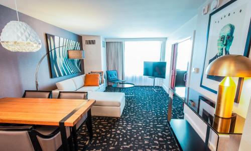 a living room with a couch and a table at Kimpton Hotel Palomar Los Angeles Beverly Hills by IHG in Los Angeles