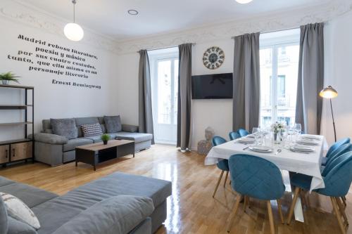 salon ze stołem i niebieskimi krzesłami w obiekcie vip PUERTA DEL SOL, by MONARO***** w Madrycie