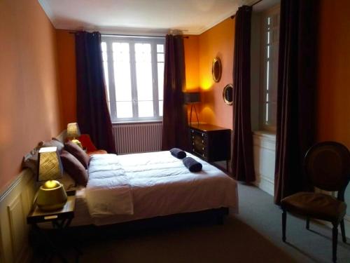 a woman laying on a bed in a bedroom at La petite duchesse - jaccuzzi in Plérin