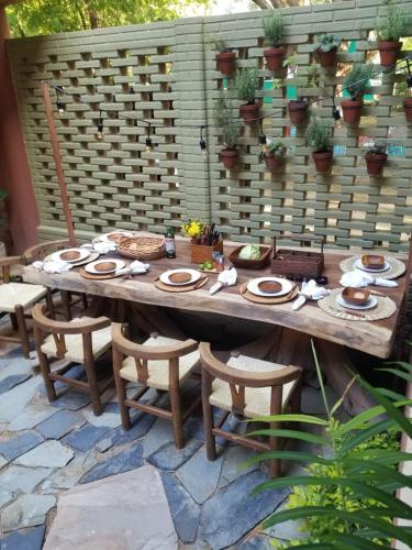 a wooden table and chairs on a patio at Hotel Bendita Luna in Mazunte