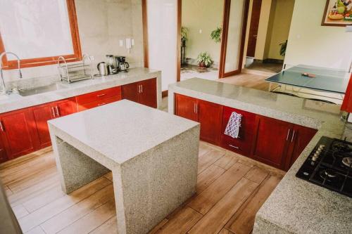 a kitchen with a island in the middle of it at Casa de Campo en Cieneguilla in Lima