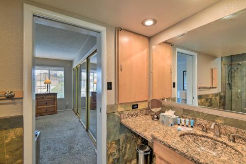 een badkamer met een wastafel en een grote spiegel bij Relaxing Phoenix House with Hot Tub and Heated Pool! in Phoenix