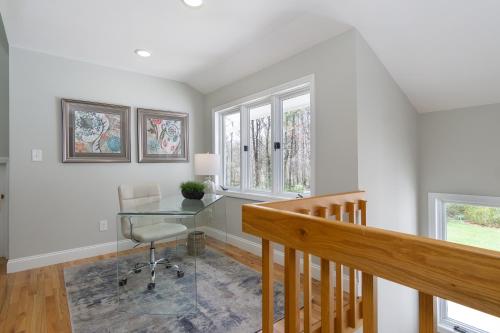 a home office with a desk and windows at Secluded oasis in Asheville! GAME room MOVIE theater HOT tub - 20 min to Biltmore! in Fairview