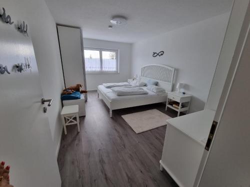a white bedroom with a bed and a mirror at Holiday Apartment Moises y Ruth in Murg