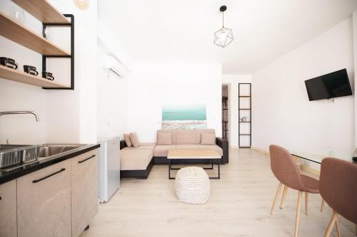 a kitchen and living room with a couch and a table at Vila Milo in Himare