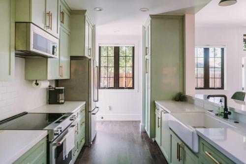 a kitchen with green cabinets and white counters at Sacramento Guest House with Patio about 5 Mi to Downtown in Sacramento