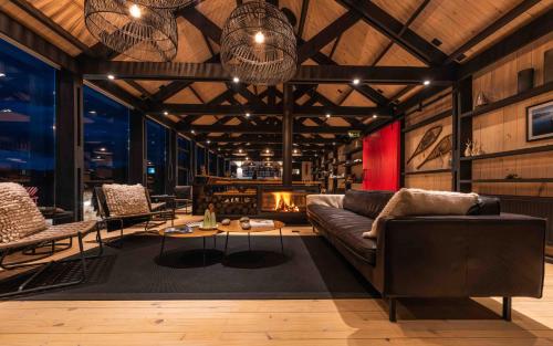 a living room with a couch and a fireplace at Kau Rio Serrano in Torres del Paine