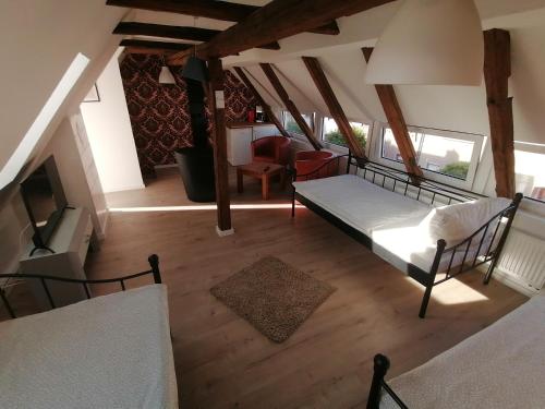 an overhead view of a bedroom with a bed and a living room at Fewo Lichtenstein in Lichtenstein