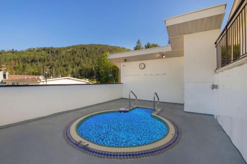 a swimming pool on the roof of a building at SureStay Hotel by Best Western Rossland Red Mountain in Rossland