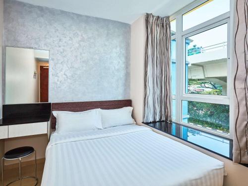 a bedroom with a large bed and a window at Ibis Budget Singapore Mount Faber in Singapore
