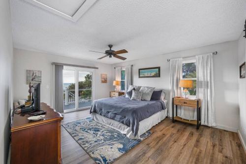 a bedroom with a bed and a ceiling fan at Breathtaking Waterfront Crystal Beach Getaway! in Palm Harbor