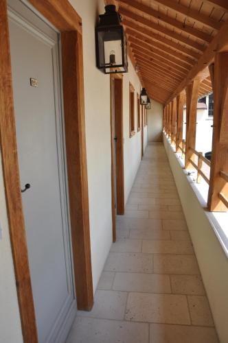 an empty corridor in a building with a light fixture at Le Clos Margot in Vertus