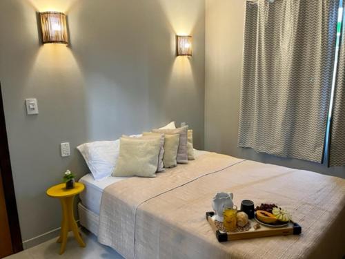 a bedroom with a bed with a tray of food on it at Casa Sol com piscina in Balneario Barra do Sul