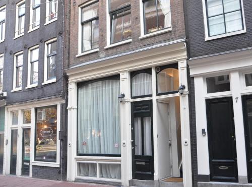 a building with white doors and windows on a street at Artist House Amsterdam in Amsterdam