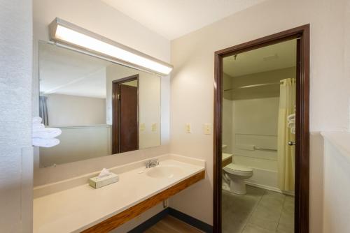 a bathroom with a sink and a toilet and a mirror at Days Inn by Wyndham Somerset PA I-70 I-76 in Somerset