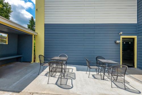 a group of chairs and tables outside a building at Days Inn by Wyndham Somerset PA I-70 I-76 in Somerset