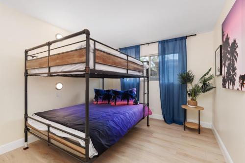 a bedroom with a bunk bed with purple sheets at Golf - Beach - Legoland - Shopping - Dining in Carlsbad