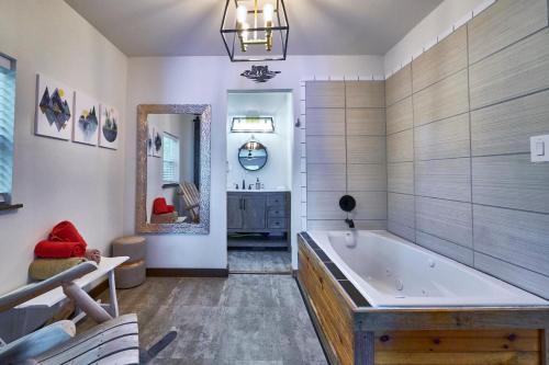 a large bathroom with a tub and a mirror at Steps from Downtown Pigeon Forge Parkway + Private Hottub and firepit - Wifi - Firefly Bungalows in Pigeon Forge