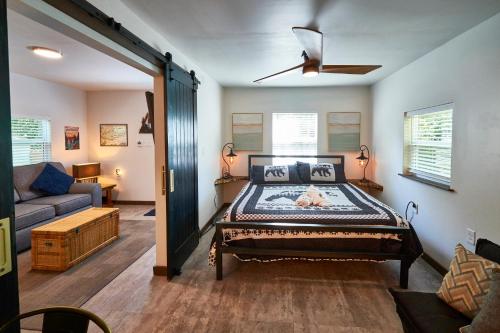 a bedroom with a bed in the middle of a room at Steps from Downtown Pigeon Forge Parkway + Private Hottub and firepit - Wifi - Firefly Bungalows in Pigeon Forge