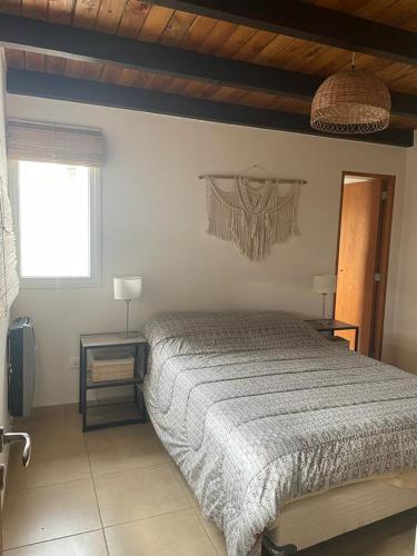 a bedroom with a large bed and a window at Casa en trevelin in Trevelín