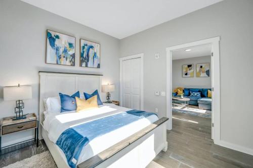 a bedroom with a large bed with blue pillows at Stylish 1br Unit. Parking. Easy Ride to NYC in Hackensack
