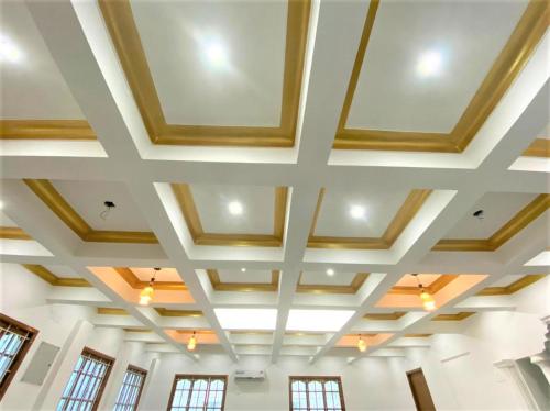 a coffered ceiling in a room with windows at Coimbatore Premium Private Villa a FAMILY RESORT kids, celebration hall in Coimbatore