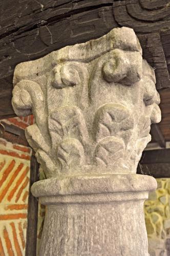a stone statue of a face on a wall at Palacio de Trasvilla in Escobedo