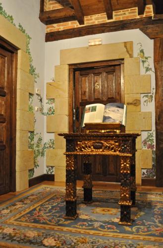 a room with a stone fireplace with a phone on it at Palacio de Trasvilla in Escobedo