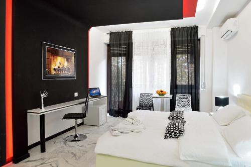 een slaapkamer met een wit bed en een bureau bij Black & White G&G in Rome