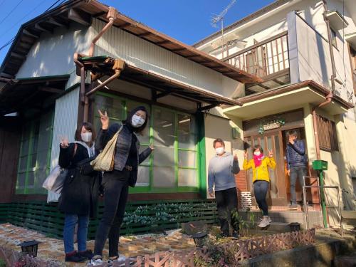 a group of people standing outside of a house at Forest Villa Hakone in Hakone
