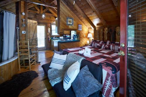 a living room with a couch in a cabin at Gatlinburg Area Hottub Cabin - Ladyslipper in Sevierville