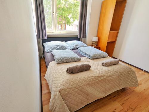 a bedroom with a bed with two pillows on it at Vacation Apartment In The Black Forest in Villingen-Schwenningen