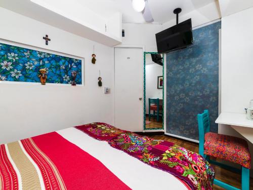 a bedroom with a bed with a cross on the wall at Casa Itzae B&B Polanquito Dog Friendly in Mexico City
