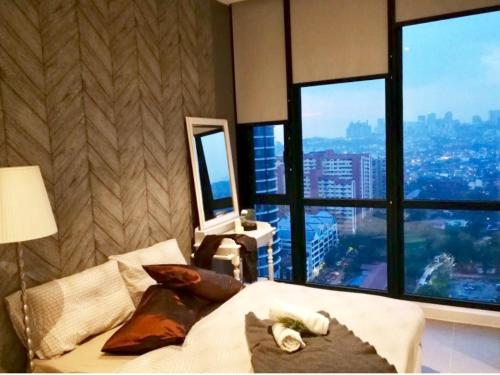 a bedroom with a bed with a view of a city at Charming Bedroom - next to train station at Est Bangsar in Kuala Lumpur