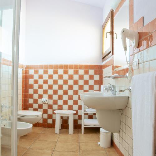 a bathroom with a sink and a toilet at Club Esse Cala Gonone in Cala Gonone