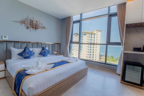 a bedroom with a large bed and a large window at Seascape Palace Hotel in Sihanoukville