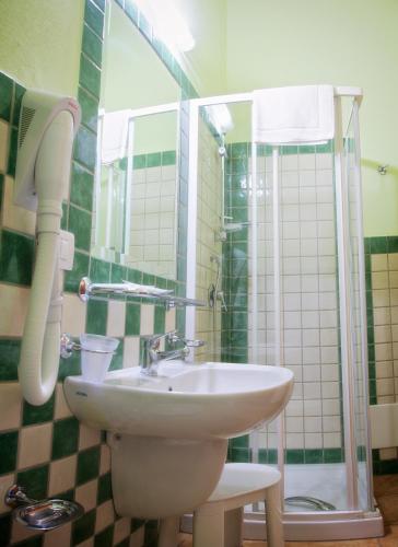 a bathroom with a sink and a shower at Club Esse Cala Gonone in Cala Gonone