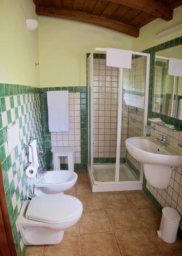 a bathroom with a toilet and a sink at Club Esse Cala Gonone in Cala Gonone