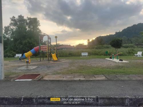 a park with a playground with a slide at Noorsyah Homestay Stadium Utama in Kangar