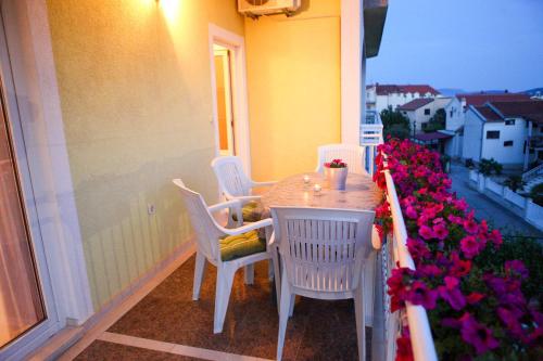 einen Tisch und Stühle auf einem Balkon mit Blumen in der Unterkunft Apartments with a parking space Vodice - 6233 in Vodice