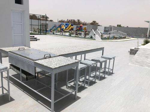 a row of tables and chairs in a skate park at VENESIA chalet in Al Kāmil