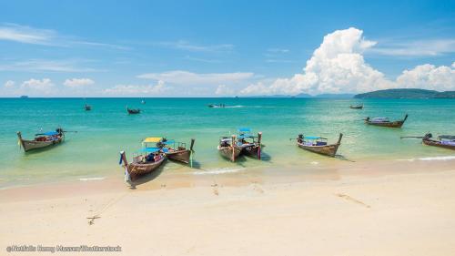 a group of boats sitting on the beach at Siya Private Pool Villa Ao Nang in Ao Nang Beach