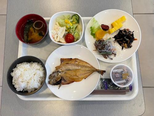 a tray of food with a fish and rice at Green Rich Hotel Hamada Ekimae (Artificial hot spring Futamata Yunohana) in Hamada