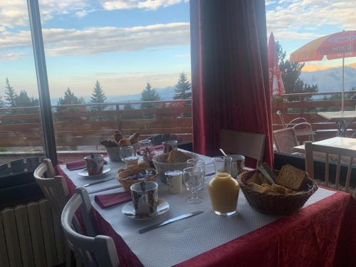 a table with plates of food on it with a view at La bagatelle in Saint-Michel-de-Chaillol