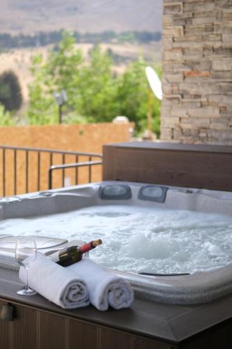 a hot tub with towels and a bottle of wine in it at Chalet de Charme, Cedar, Lebanon, ENTIRE CHALET in Al Arz