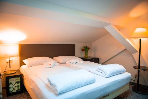 a bedroom with a bed with two pillows on it at Bölsche Hotel in Berlin